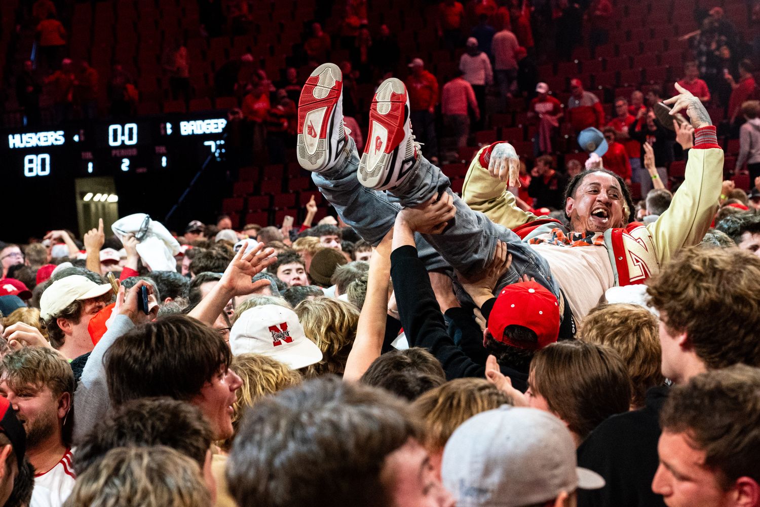 Feb 1, 2024; Lincoln, Nebraska, USA; Nebraska Cornhuskers fans celebrate after the Huskers defeated the Wisconsin Badgers at Pinnacle Bank Arena.